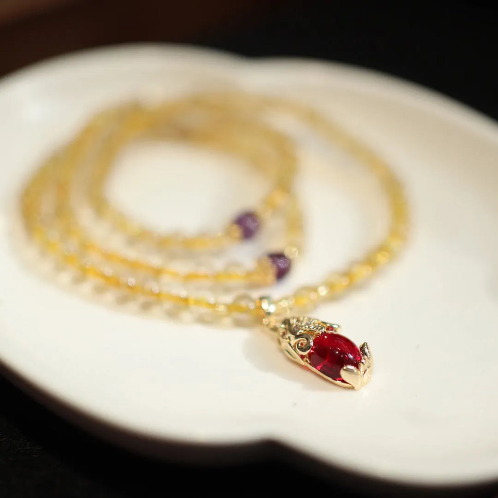 Handmade natural gold rutilated quartz bracelet in Chinese three-ring style with hanging chopsticks.