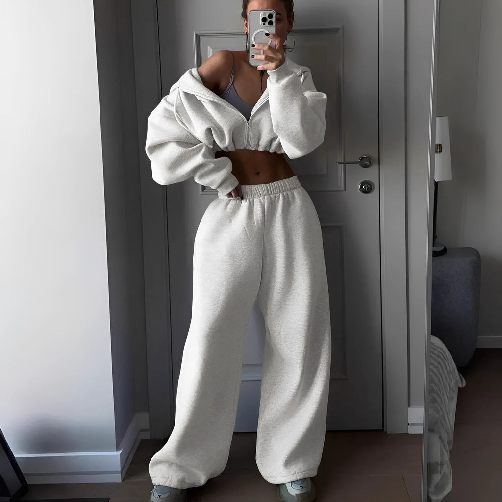 Long sleeve polyester sports suit two-piece set in light grey, shown as coat and trousers.