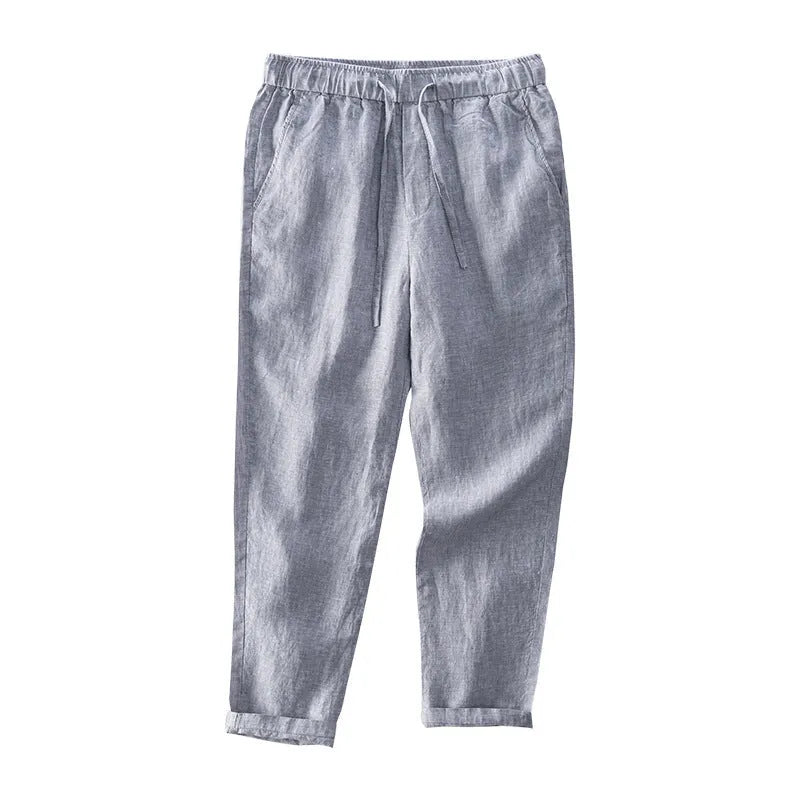 Men's straight leg linen trousers in light grey colour, showing mid waist and tailored fit.