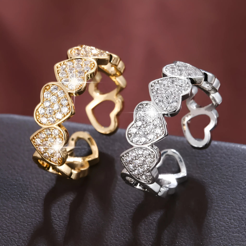 Gold or silver adjustable openable heart-shaped couples ring on a copper base.