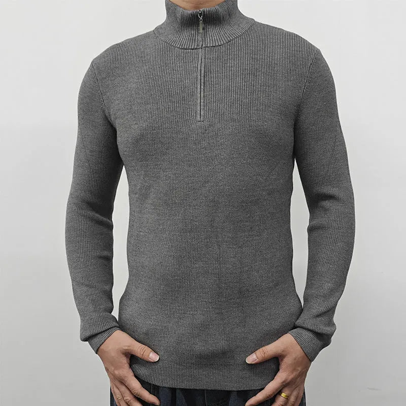 Man wearing a grey half turtleneck zip-front sweater, a casual cotton blend pullover.