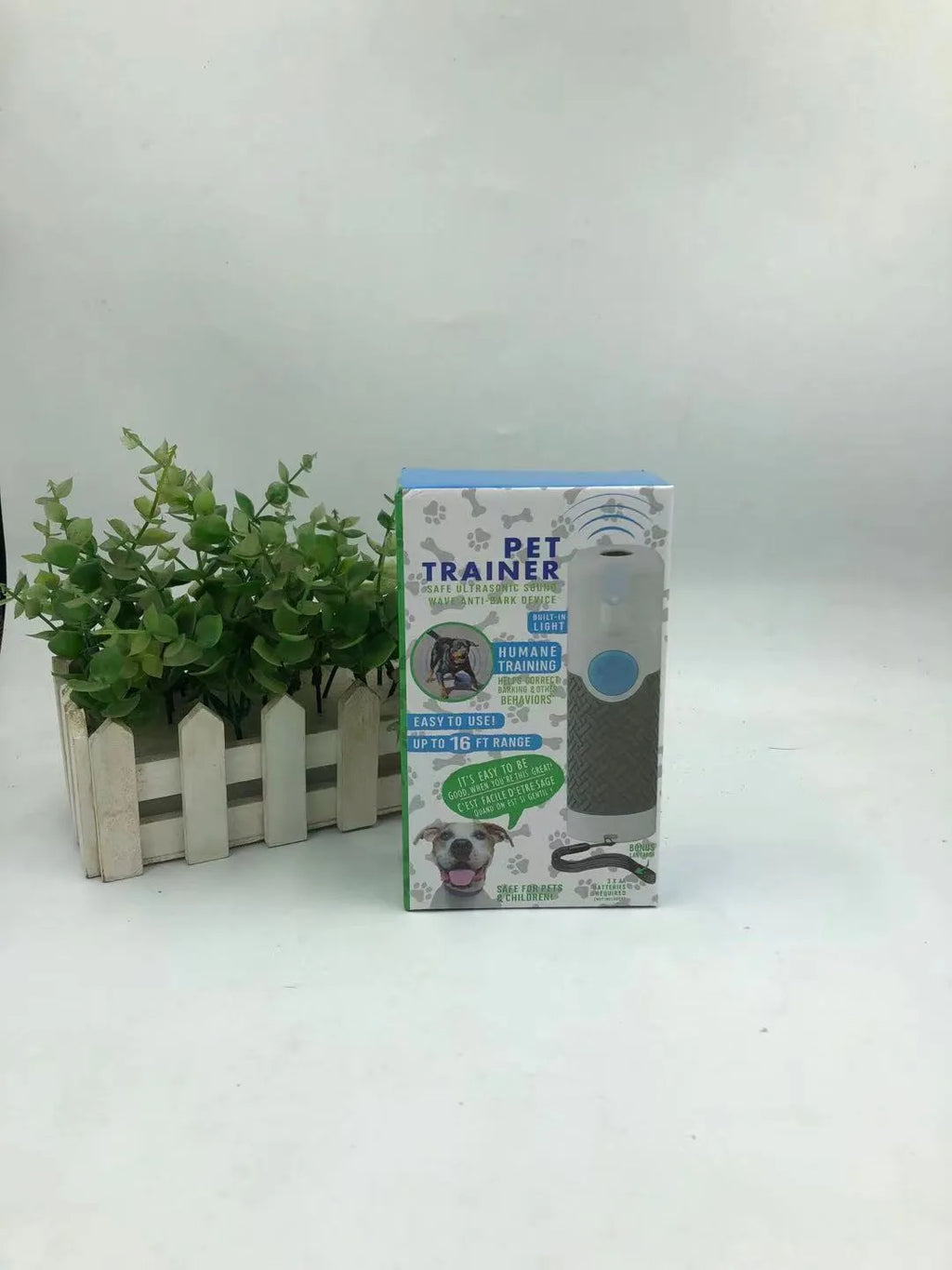 White handheld ultrasonic dog trainer device with LED light for bark control and behaviour correction