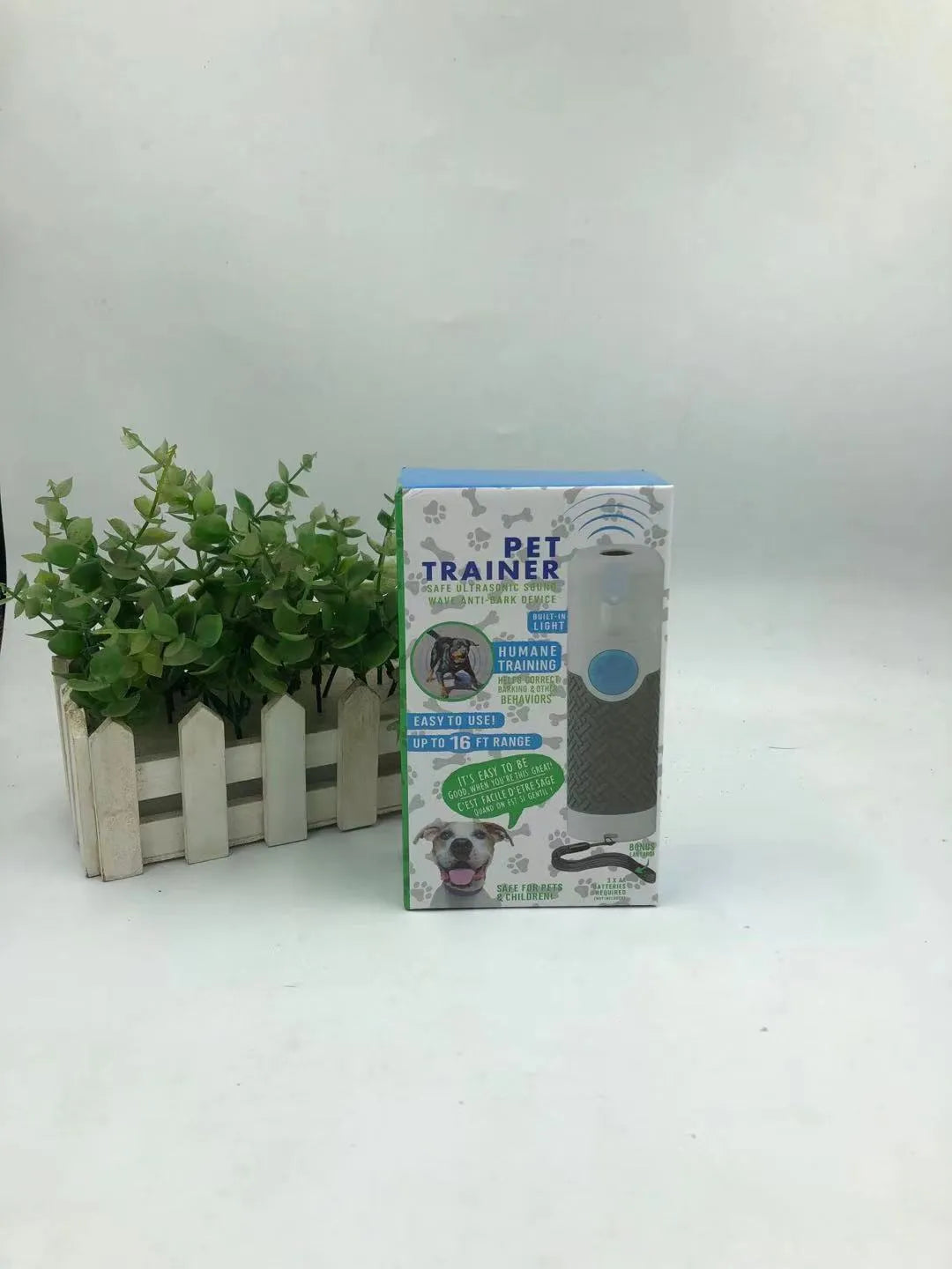 White handheld ultrasonic dog trainer device with LED light for bark control and behaviour correction