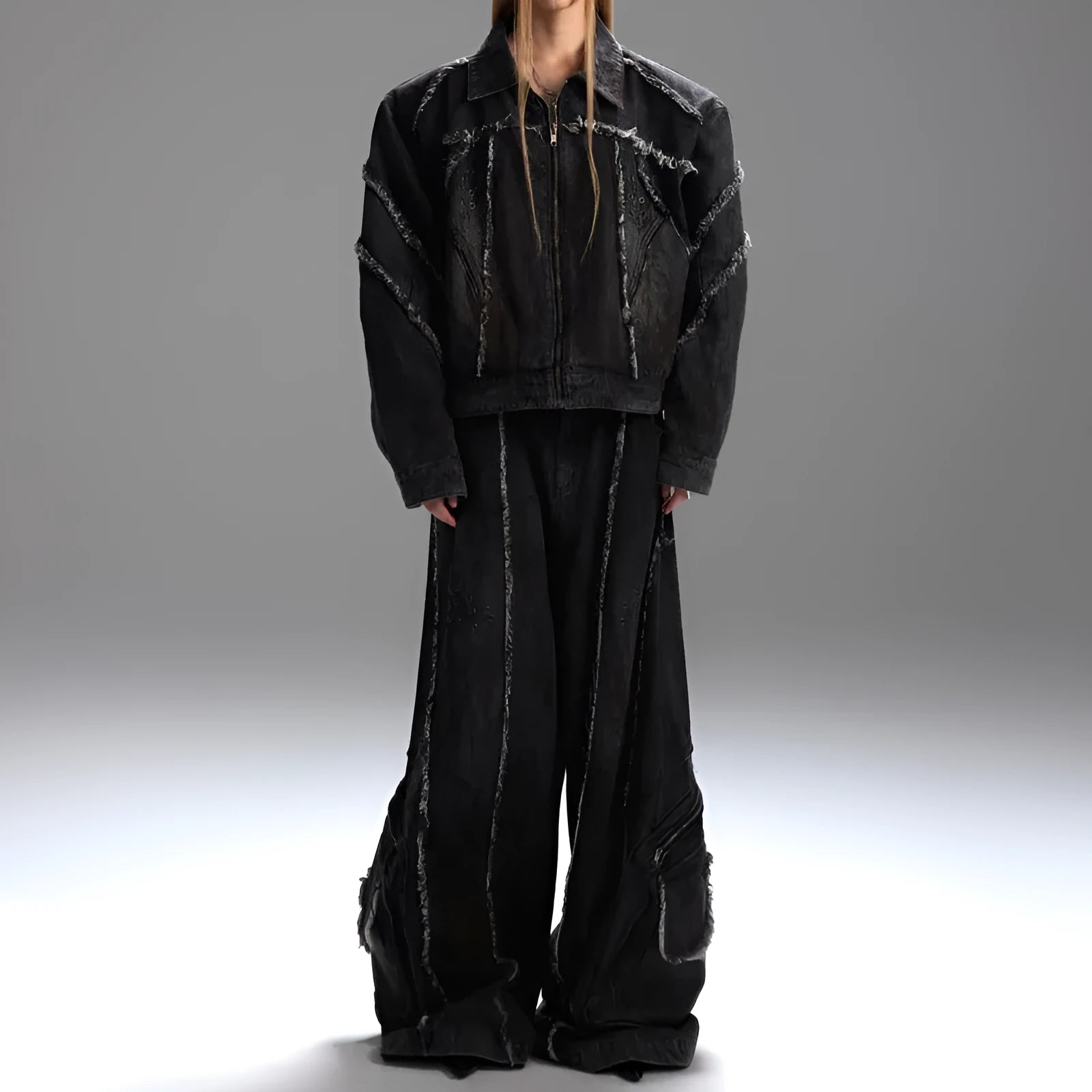 Black gradient distressed denim coat with padded shoulders and matching trousers on a hanger.