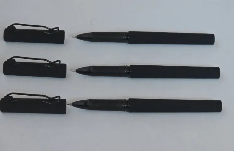 Three black decompression elastic pens with 0.7mm bullet tips and cap closure on a light background