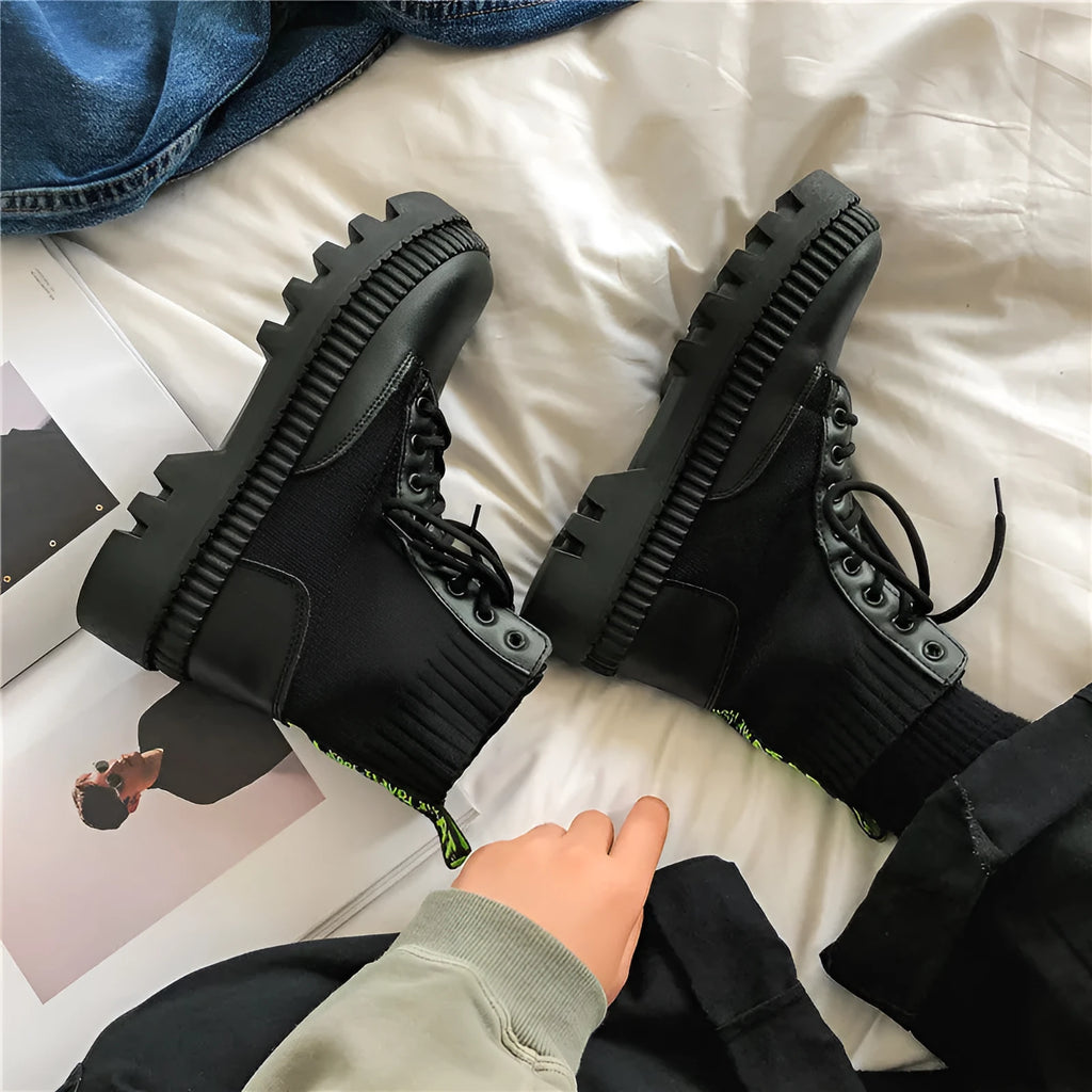 Black men's Dr. Martens platform boots with a side zipper and frosted leather upper.