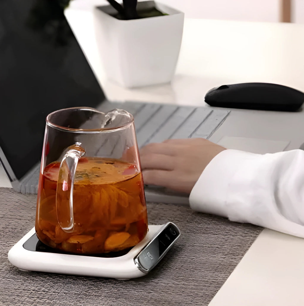 Black USB coffee mug warmer on a desk with a mug, showing three-speed control and tempered glass top.