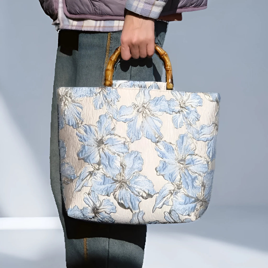 Light blue women's canvas shoulder bag with gold bronzing flower detailing showing horizontal square shape