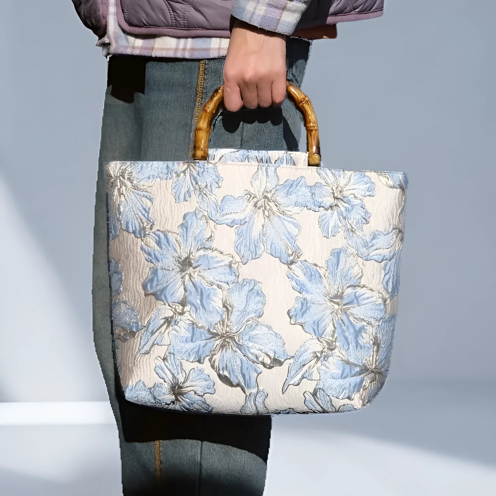 Light blue women's canvas shoulder bag with gold bronzing flower detailing showing horizontal square shape
