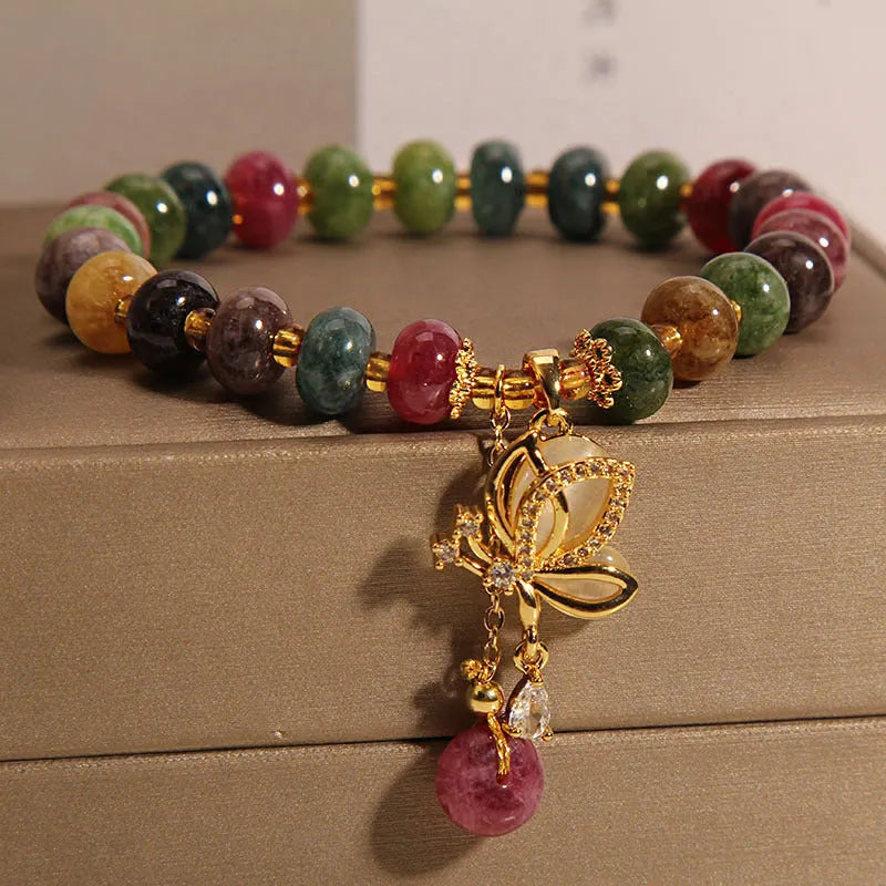 Colourful women's bracelet with a silver butterfly charm and multicoloured beads including tourmaline