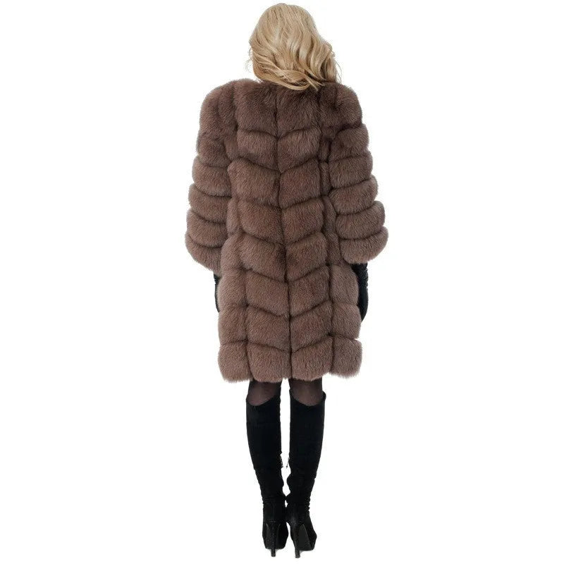 Women's long black artificial fur coat with regular sleeves on a hanger.
