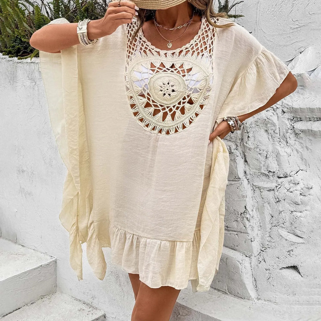 Woman wearing a crochet-tassel patchwork skirt dress as a beach cover-up in apricot colour.