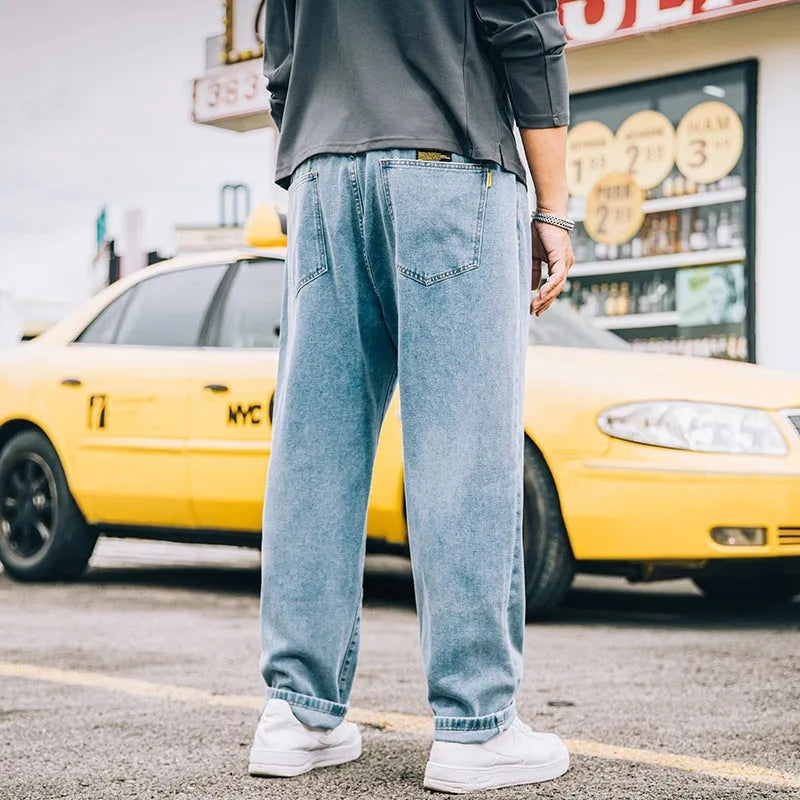 Men's loose straight cotton jeans in dark blue colour showing mid waist and zipper fly design