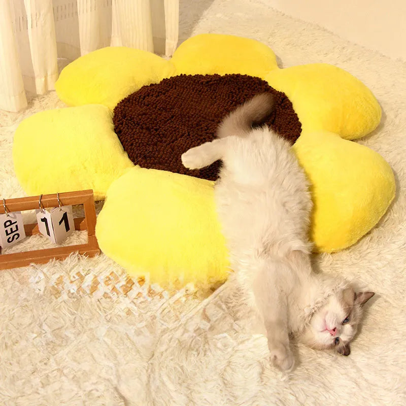 Blue round flower-shaped plush pet nest bed for cats on a wooden floor