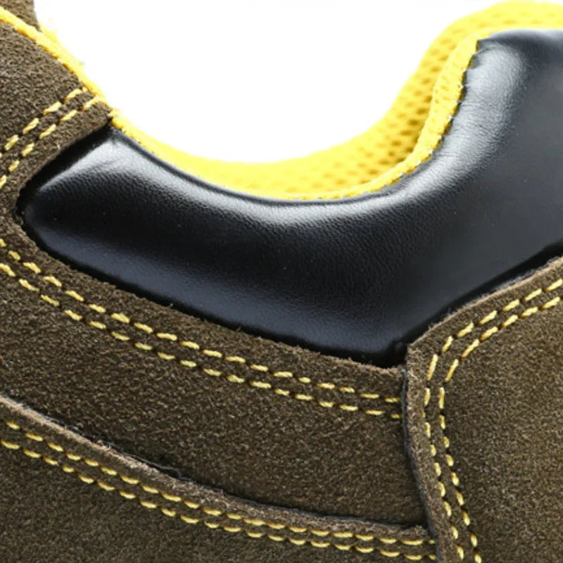 Bronze coloured low-cut cow suede leather safety shoes with a steel toe cap on a work surface.