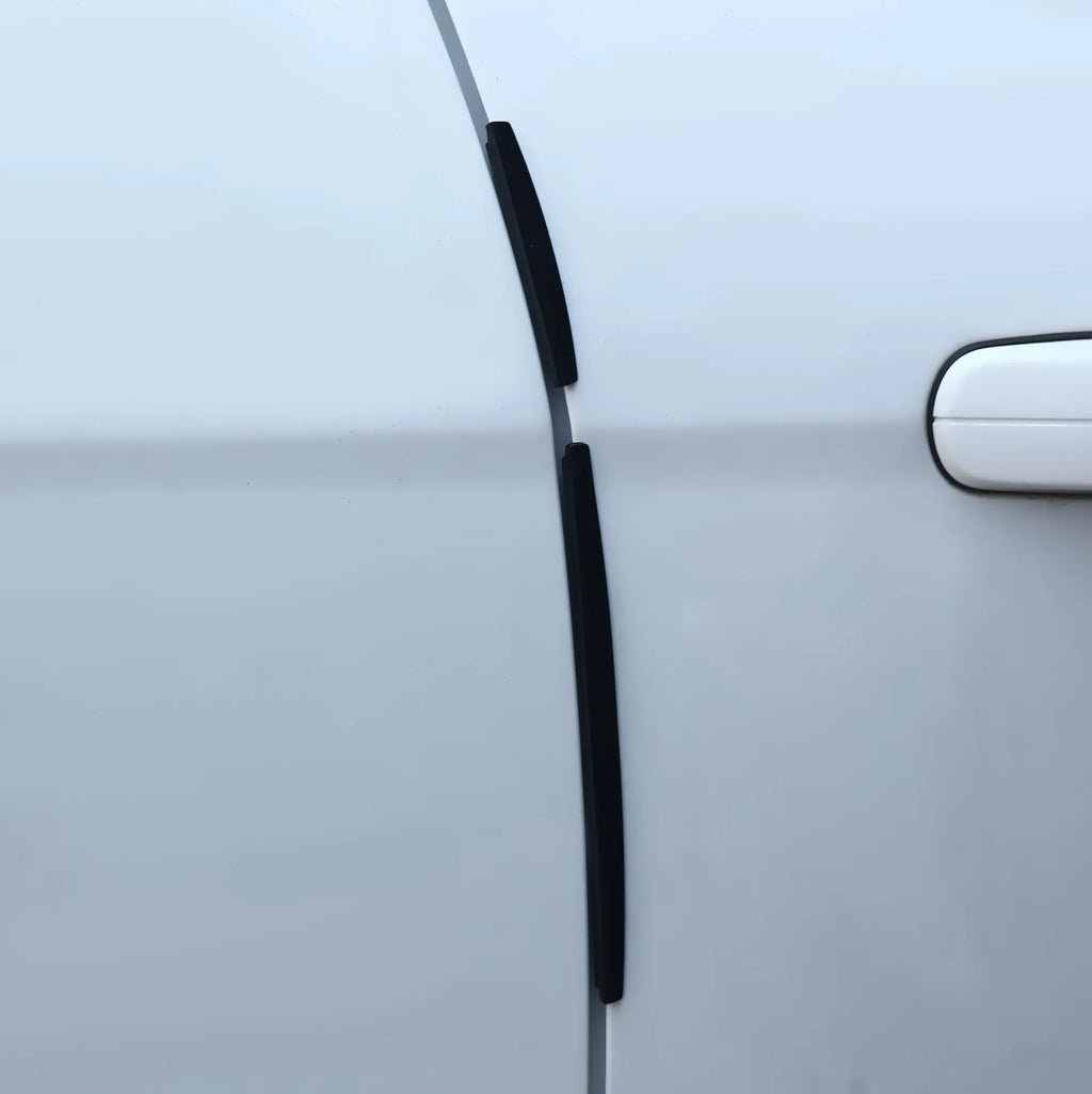 White plastic car door edge anti-collision protection strip on a vehicle.