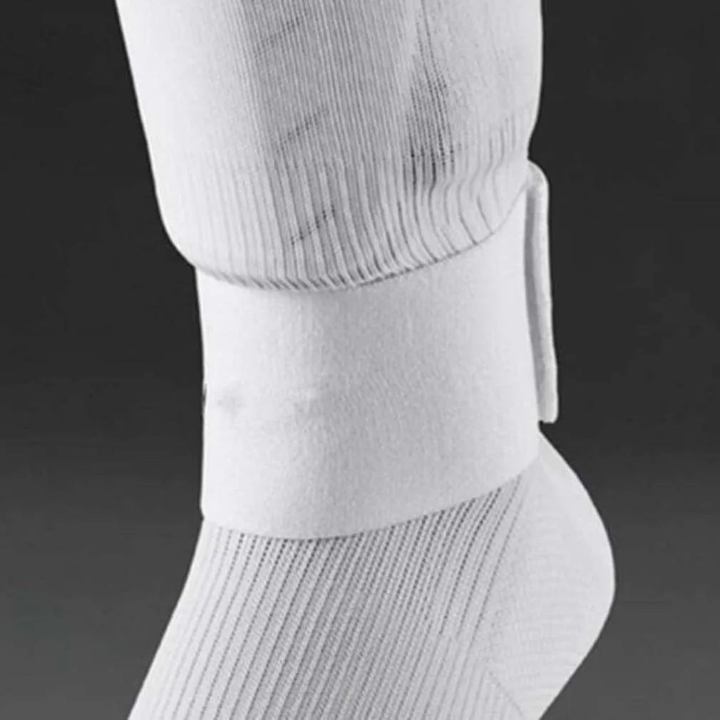 Rubber shin guard strap for football, shown in one of four colours: black, blue, red, or white.