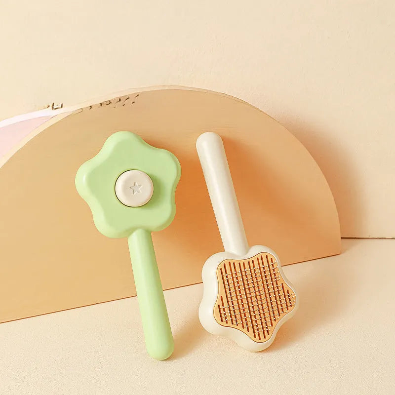 Green self-cleaning cat comb with four stainless steel needles measuring 20cm long