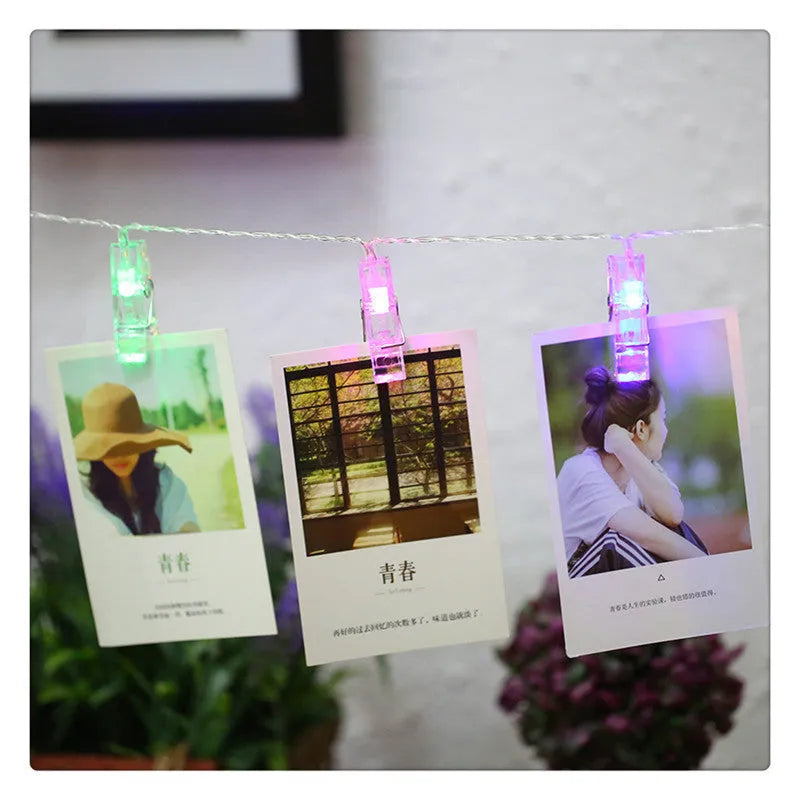 LED decorative light string with white heart-shaped clips spaced along its length, illuminated with warm white LEDs.