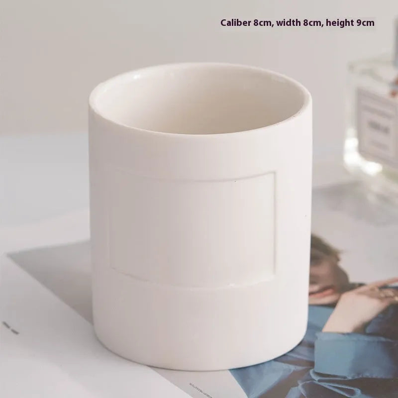 Ceramic candlestick with minimalist relief pattern on a dining table