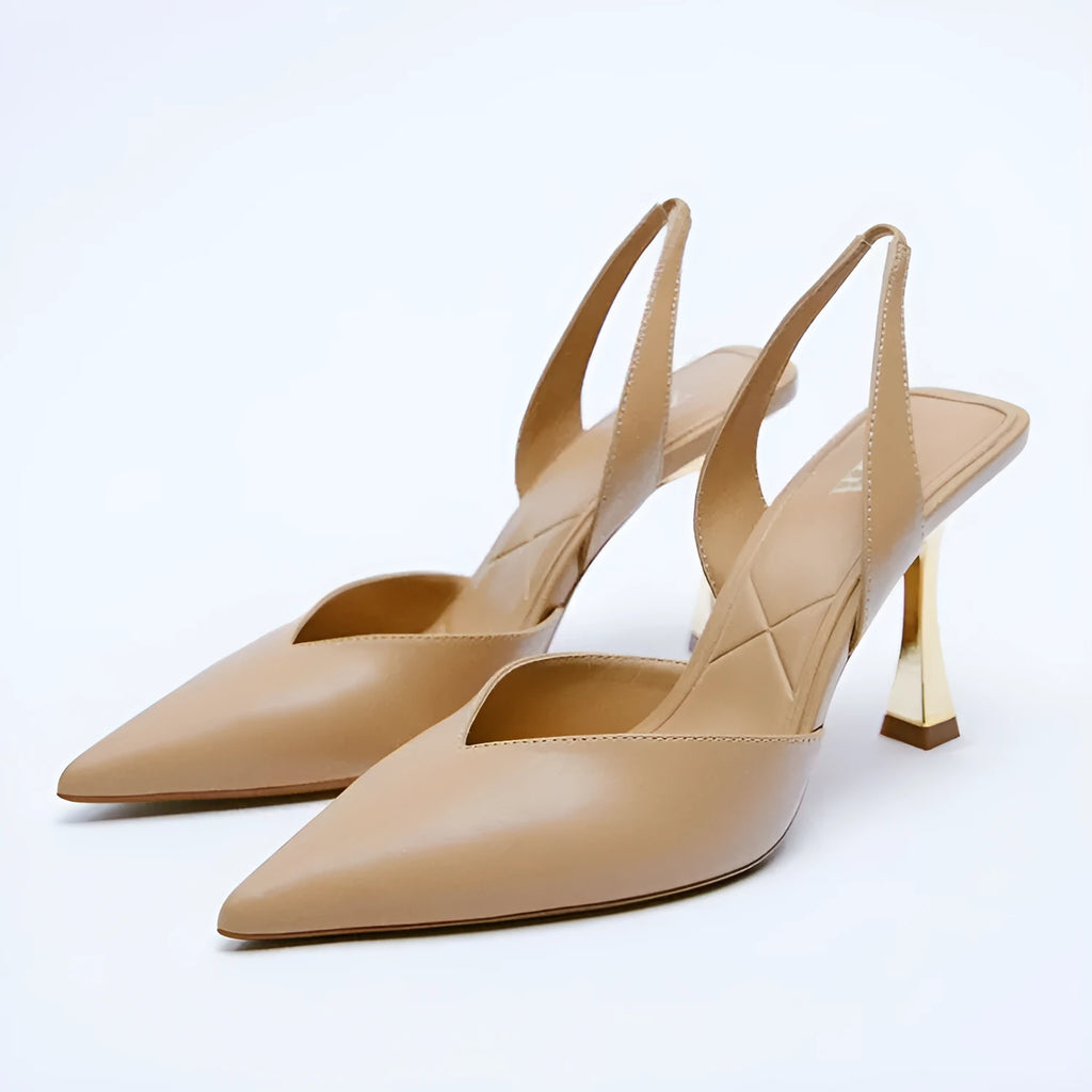 Women's nude apricot pointed toe patent leather high heels on a white background.