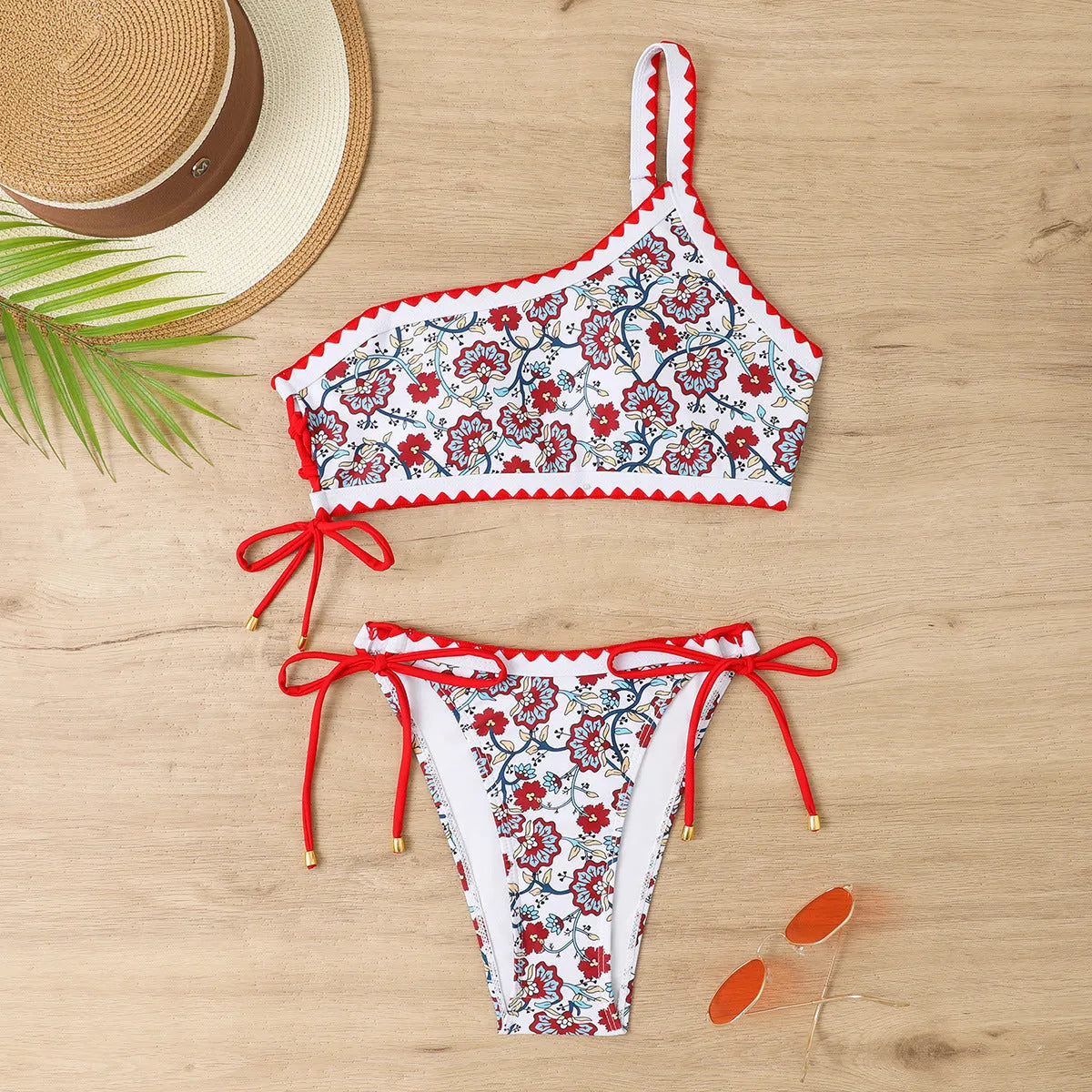 Blue one-shoulder women's floral bikini set with brief bottoms on mannequin