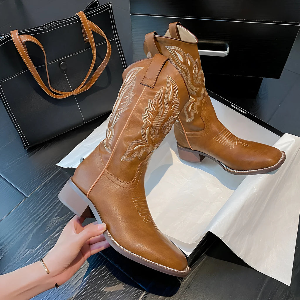 Brown women's mid-calf embroidered Martin boots with a leather lining and a low square heel.