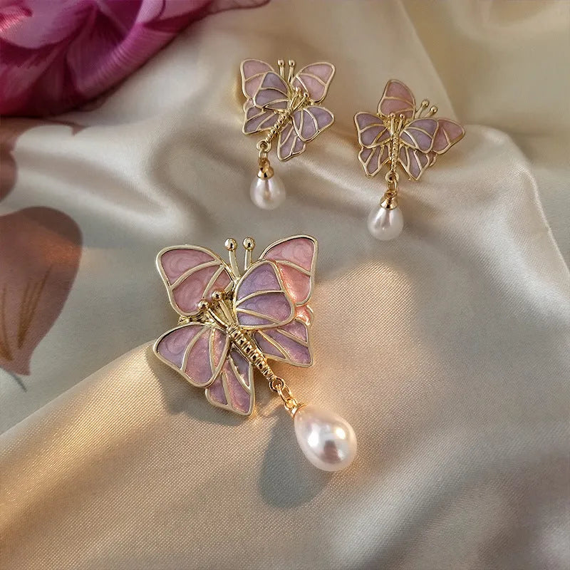 Vintage enamel butterfly brooch with pearl accents on alloy base