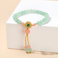 Green crystal bracelet with adjustable string closure on wrist
