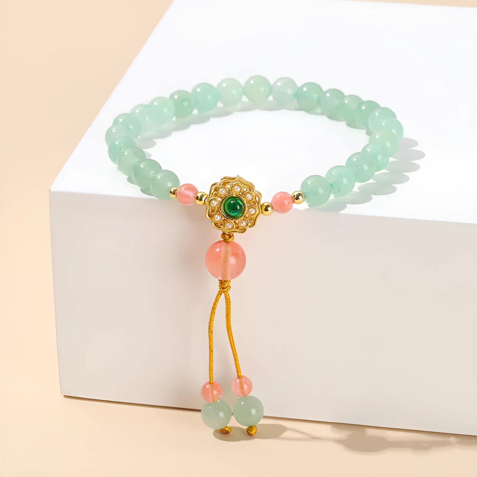 Green crystal bracelet with adjustable string closure on wrist