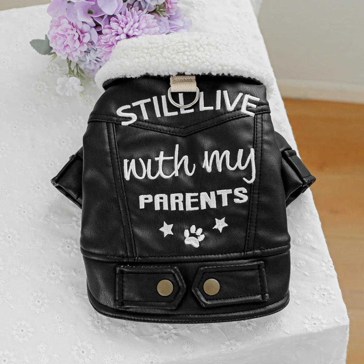 Dog wearing fleece lined padded coat with large fur trim collar in black colour