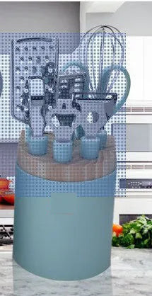 Stainless steel kitchen gadgets set with whisk, peeler, scissors, and fruit knife on grey tray