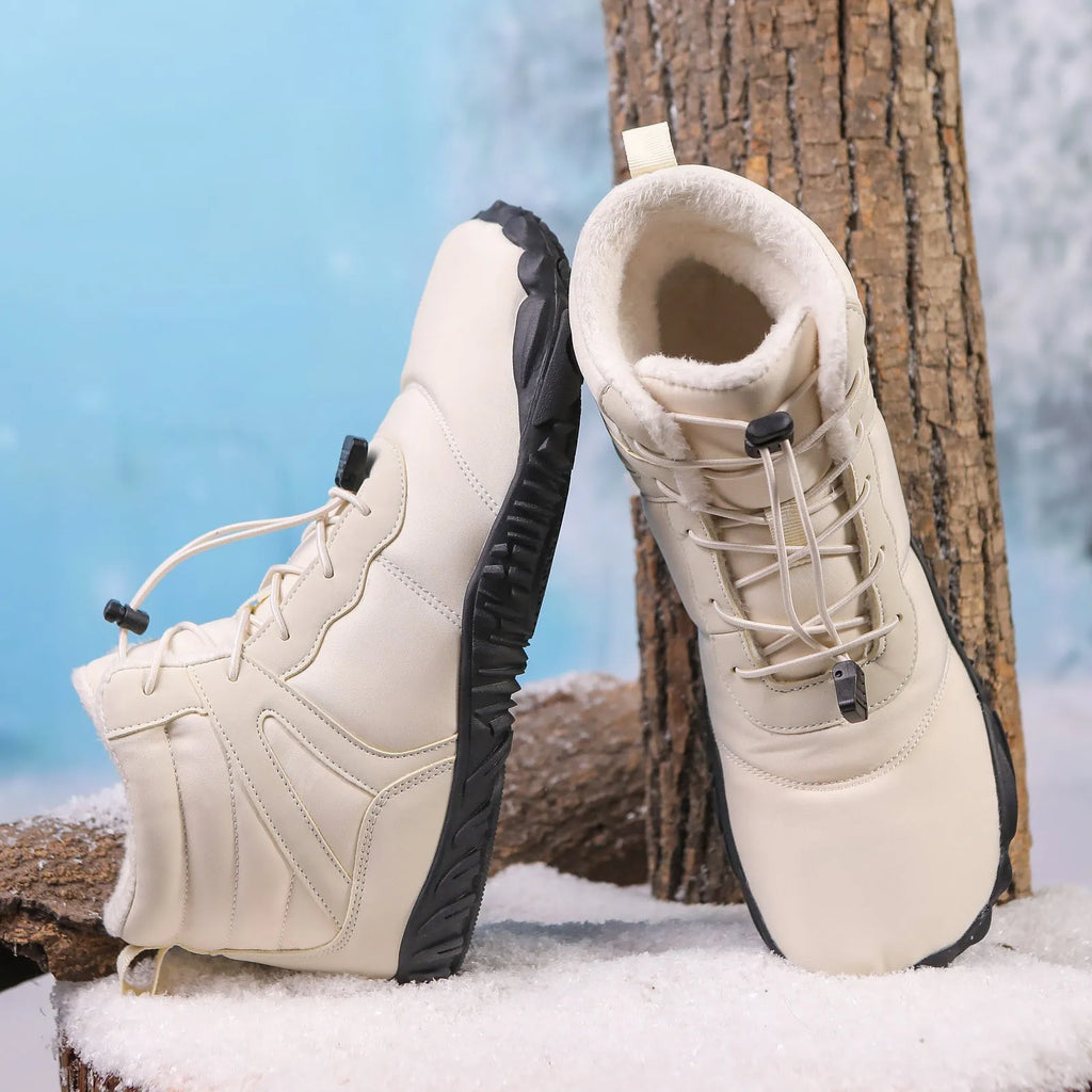 Beige five-finger waterproof snow boots with rubber sole and fleece lining on outdoor ground.