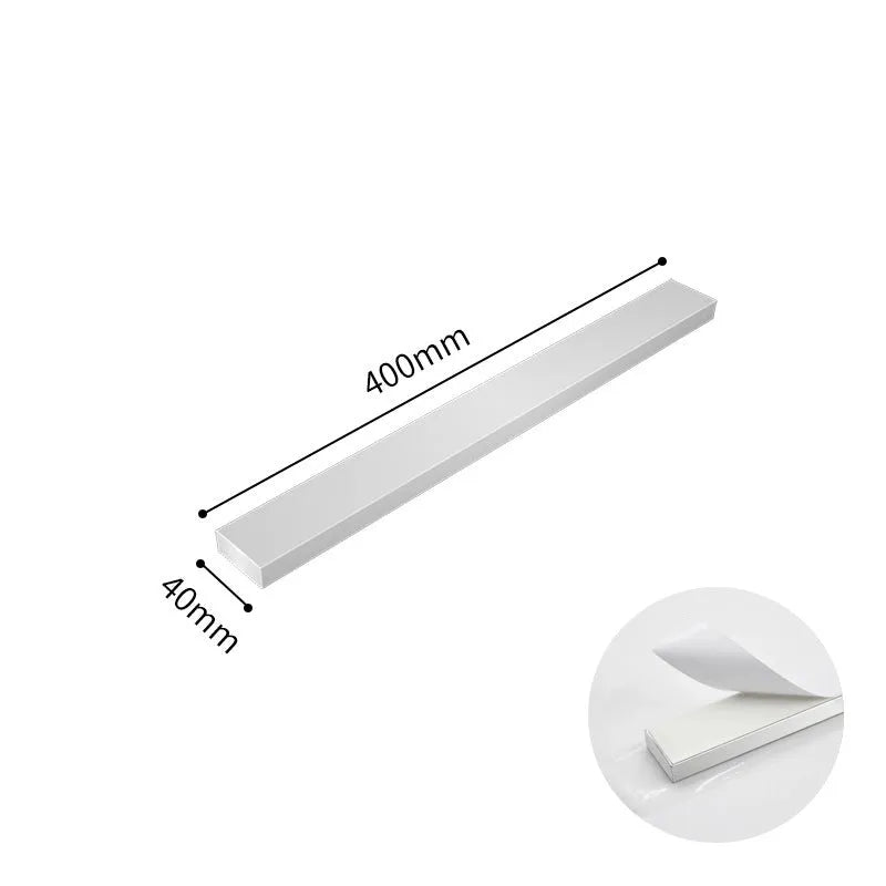 Stainless steel wall-mounted kitchen knife storage rack on white wall