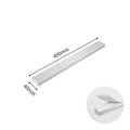 Stainless steel wall-mounted kitchen knife storage rack on white wall