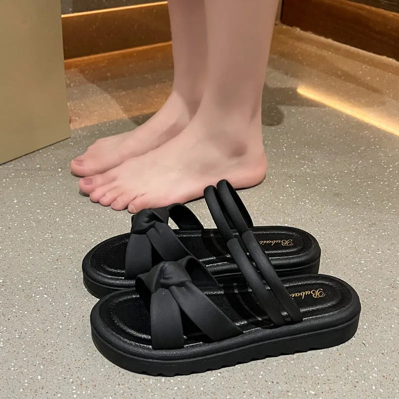 Women's black outdoor sandals with thick soft back and flower detailing on PVC upper