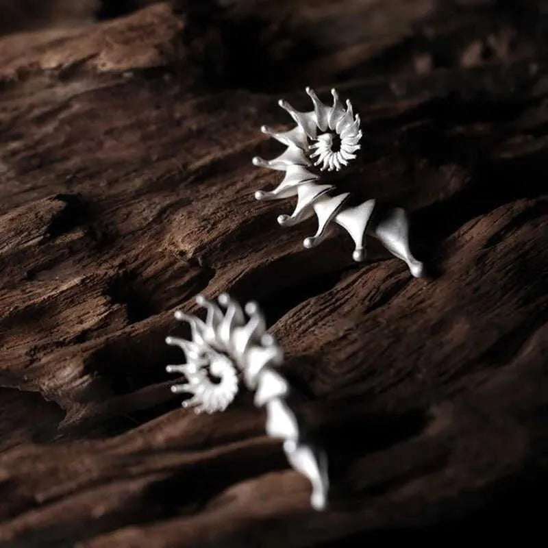 Exaggerated three-dimensional conch stud earrings with matte electroplated alloy finish
