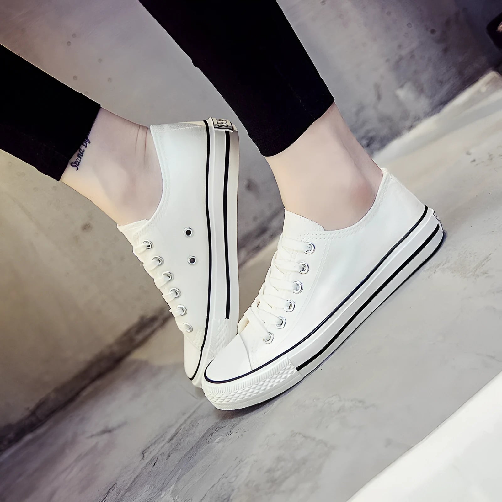 Women's solid colour canvas slip-on sneaker in black on a white background.
