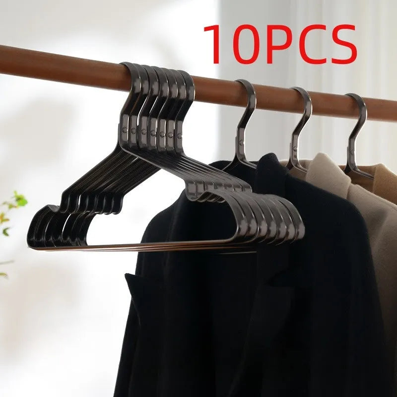 Modern elegant black clothes hanger with non-slip surface on a white background.