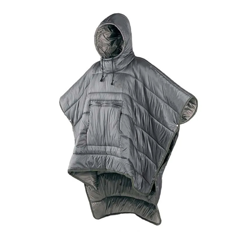 Grey outdoor cloak sleeping bag worn as a cape, showing its large 200x140cm size and hooded design.