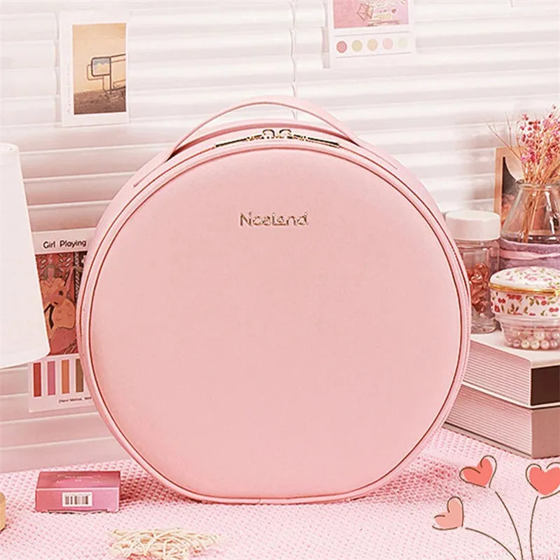 Round black PU leather makeup bag with open lid showing internal LED mirror and cosmetic partitions.