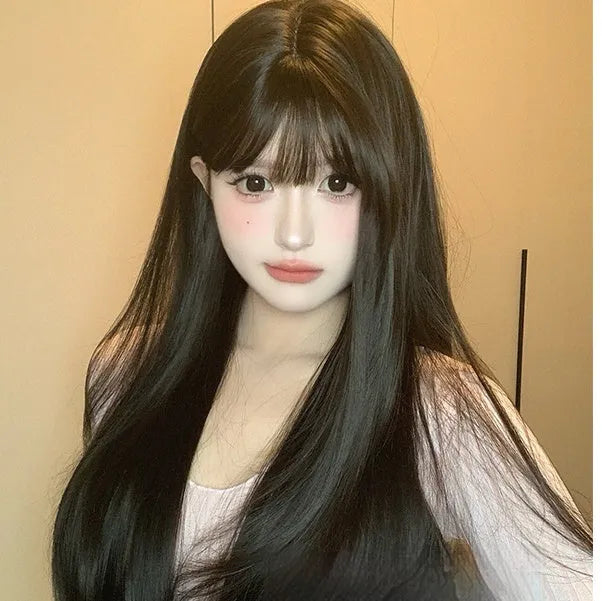 Dark brown long straight synthetic wig with bangs on a wig head.