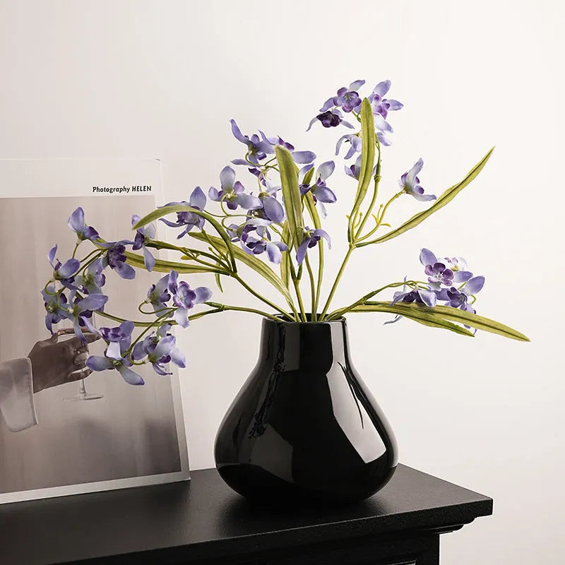 Ceramic round belly vase with coloured glaze finish and two orchid flowers in modern simplicity design