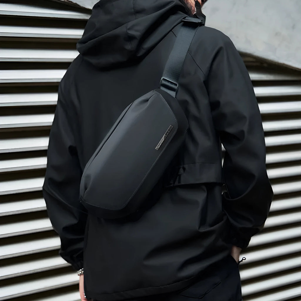 Black men's messenger bag made from Oxford cloth with a crossbody strap.