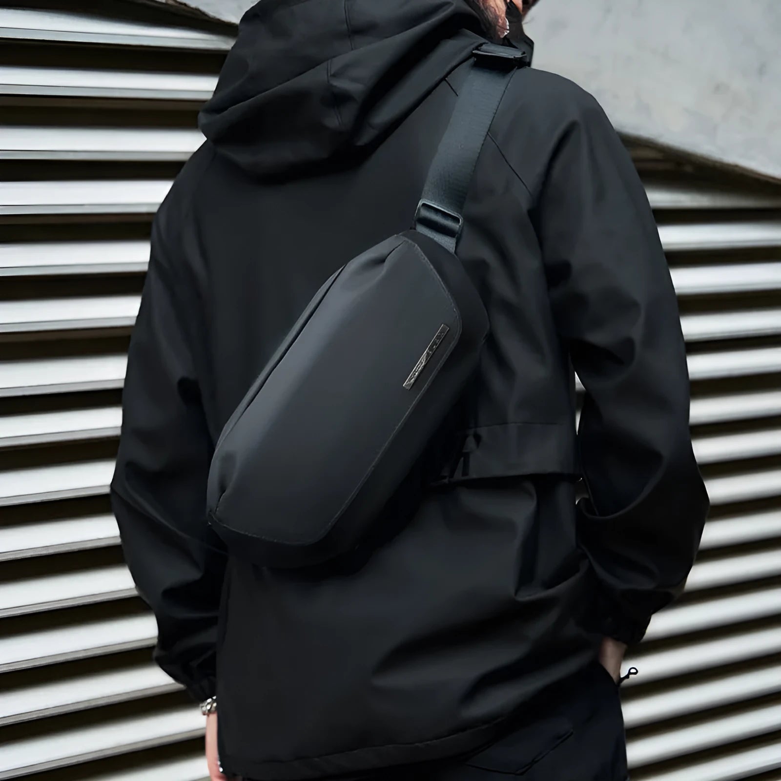 Black men's messenger bag made from Oxford cloth with a crossbody strap.