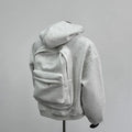 Men's grey hoodie jacket with back schoolbag design detail showing front and back views
