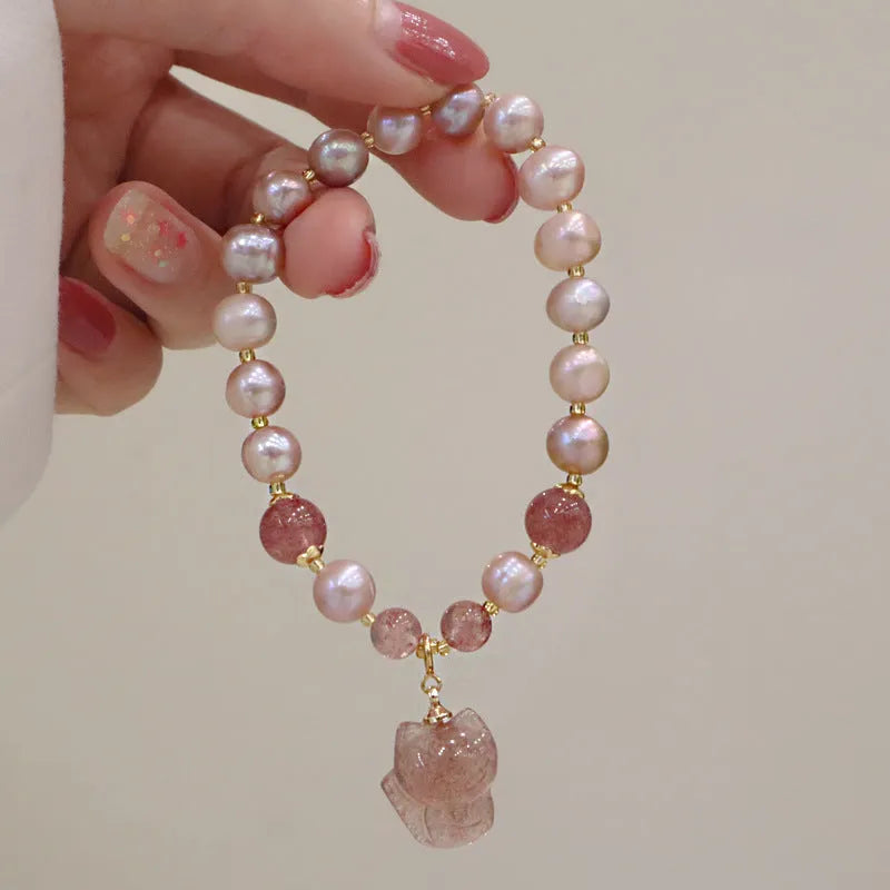 Light pink women's freshwater pearl bracelet with strawberry quartz stones and fox charm