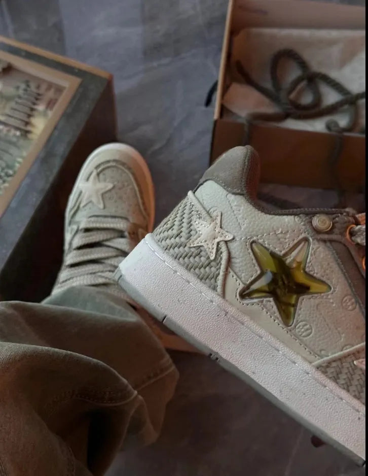 Green star print low-top casual sneakers with a lace-up front and thick rubber sole.