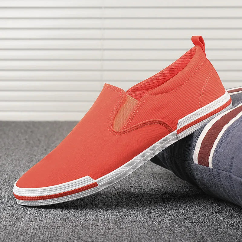 Men's low-top canvas sneakers in grey, black orange, and khaki colours with round toe and vulcanised rubber soles