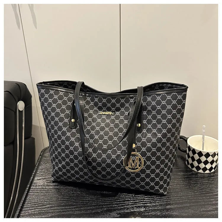 Black PU shoulder bag with sewing thread detail, showing interior polyester lining.